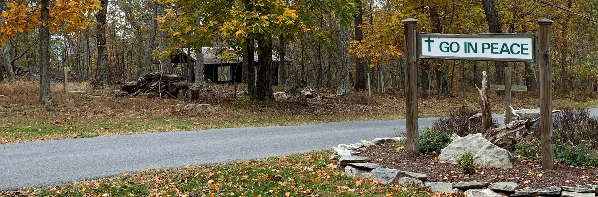 Driveway leaving Mar-Lu-Ridge. Sign says Go in Peace.