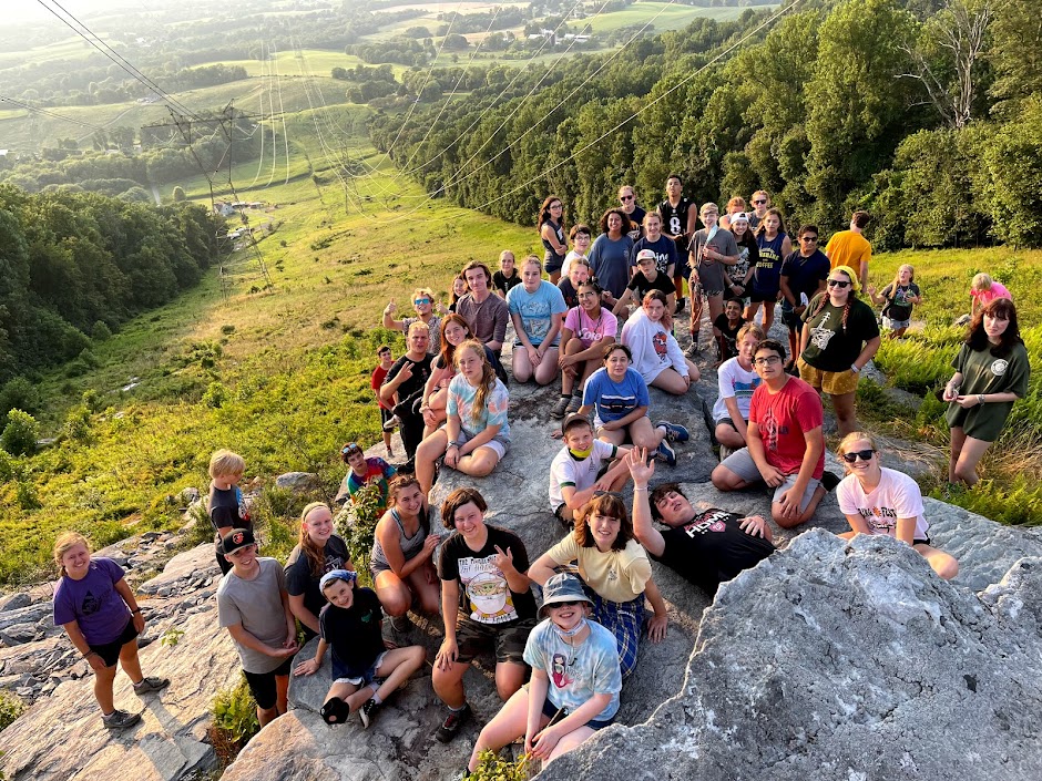 Campers sitting on the rocks after a hike