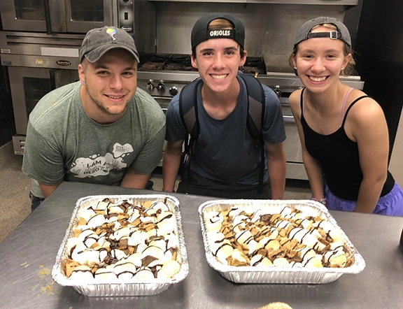 staff in the kitchen anticipating a pan of smores