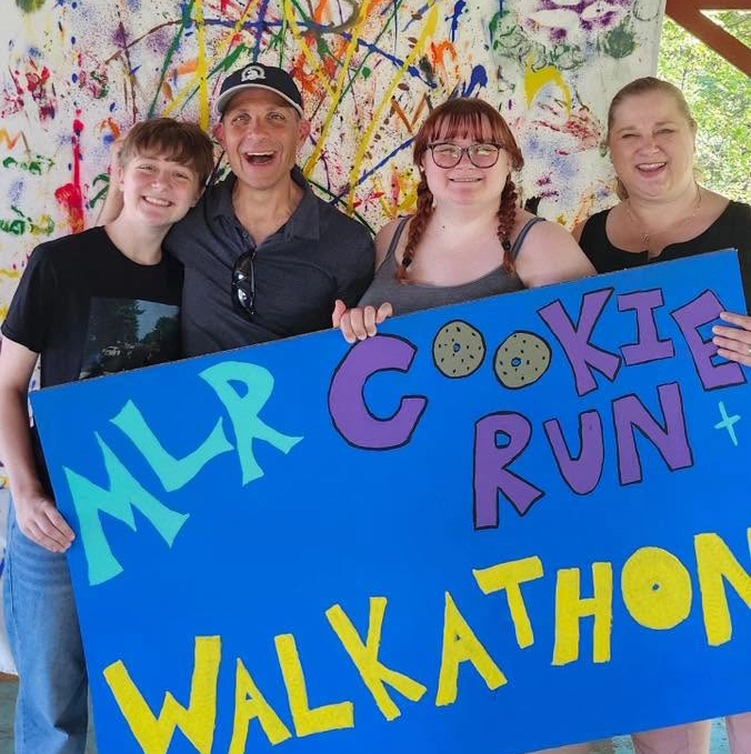 Walkathon and Cookie Run group holding sign